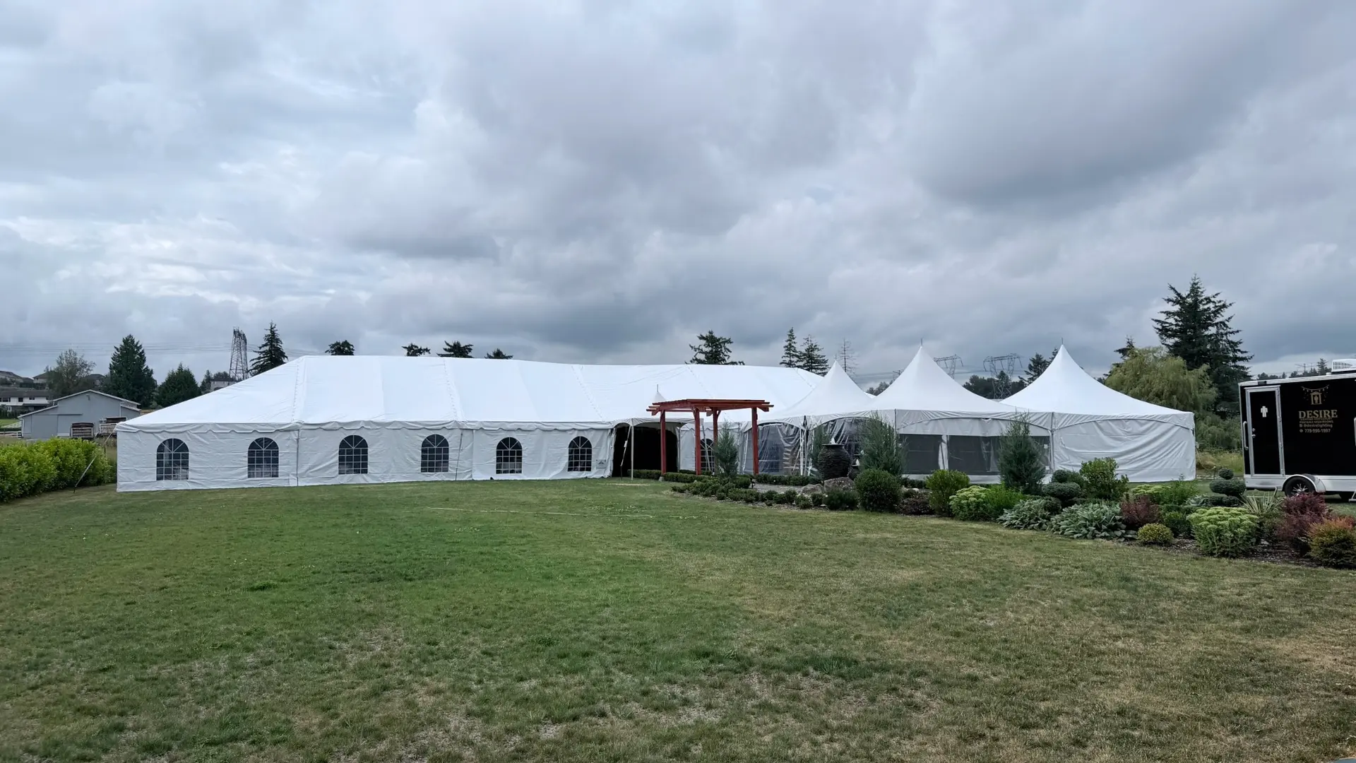 Large classic frame tent connected to high-peak event tents